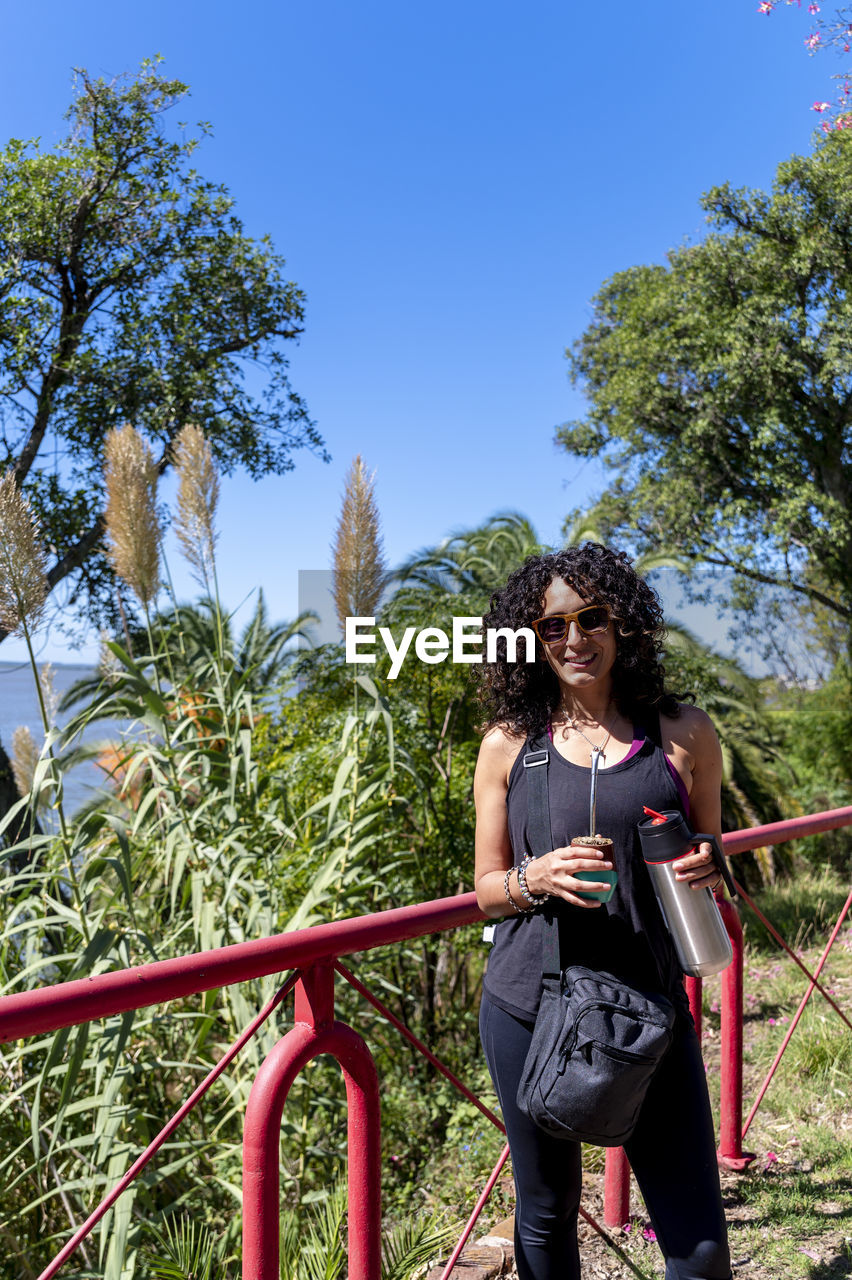 Tourist woman drinking a mate while exploring outdoors.