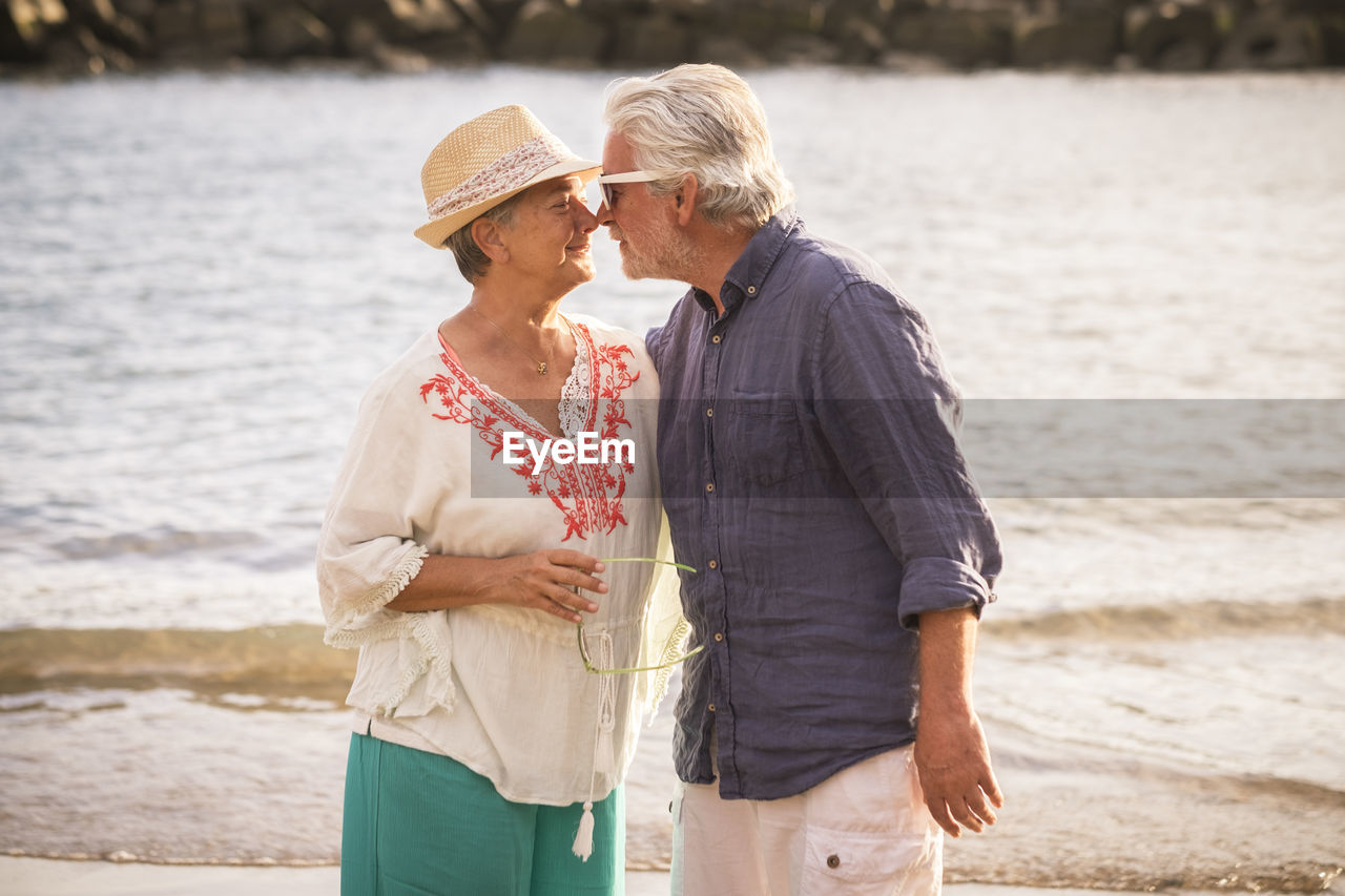 Romantic senior couple standing at beach