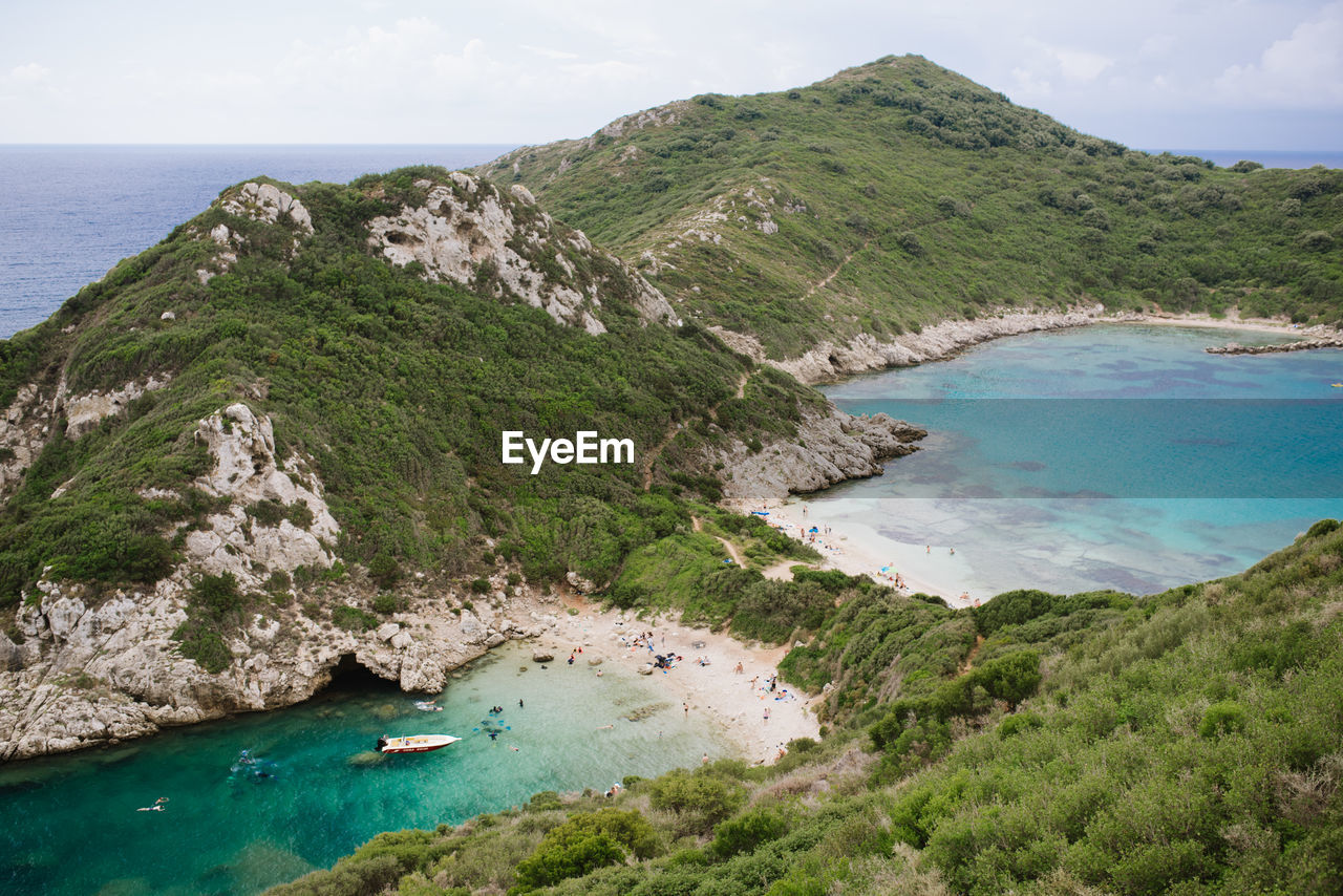 High angle view of sea and mountains against sky