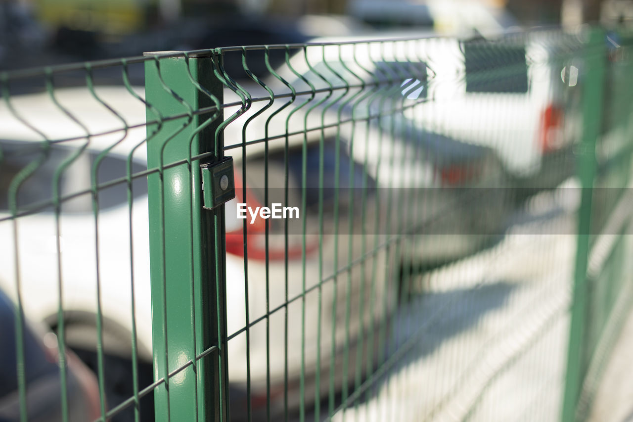 metal, cage, no people, close-up, pet, focus on foreground, architecture, outdoors, day, fence, selective focus