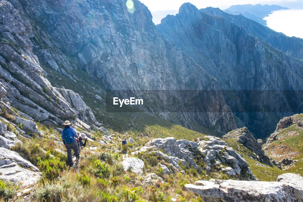 Hikers trekking down steep mountain