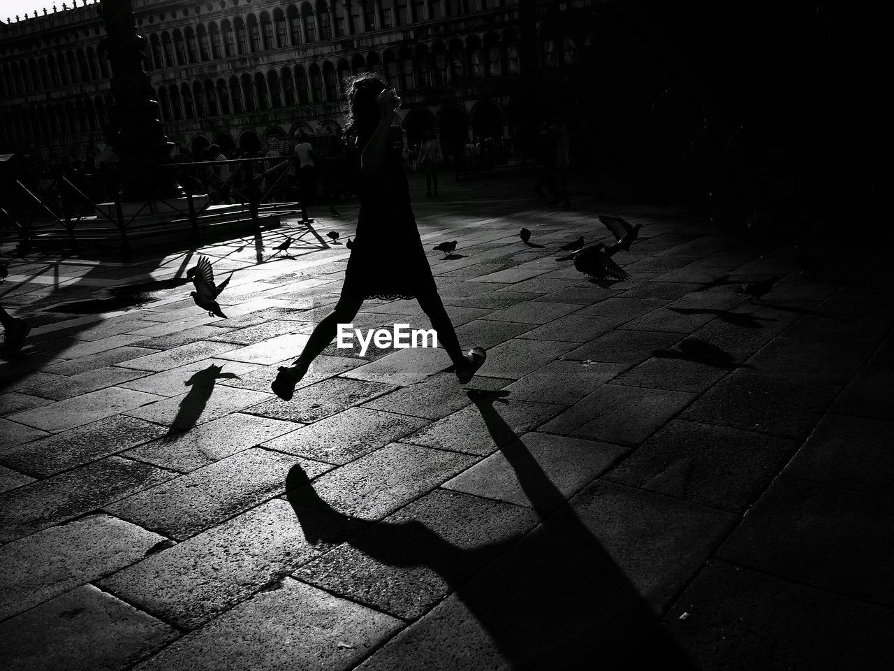 SHADOW OF PERSON ON RAILING