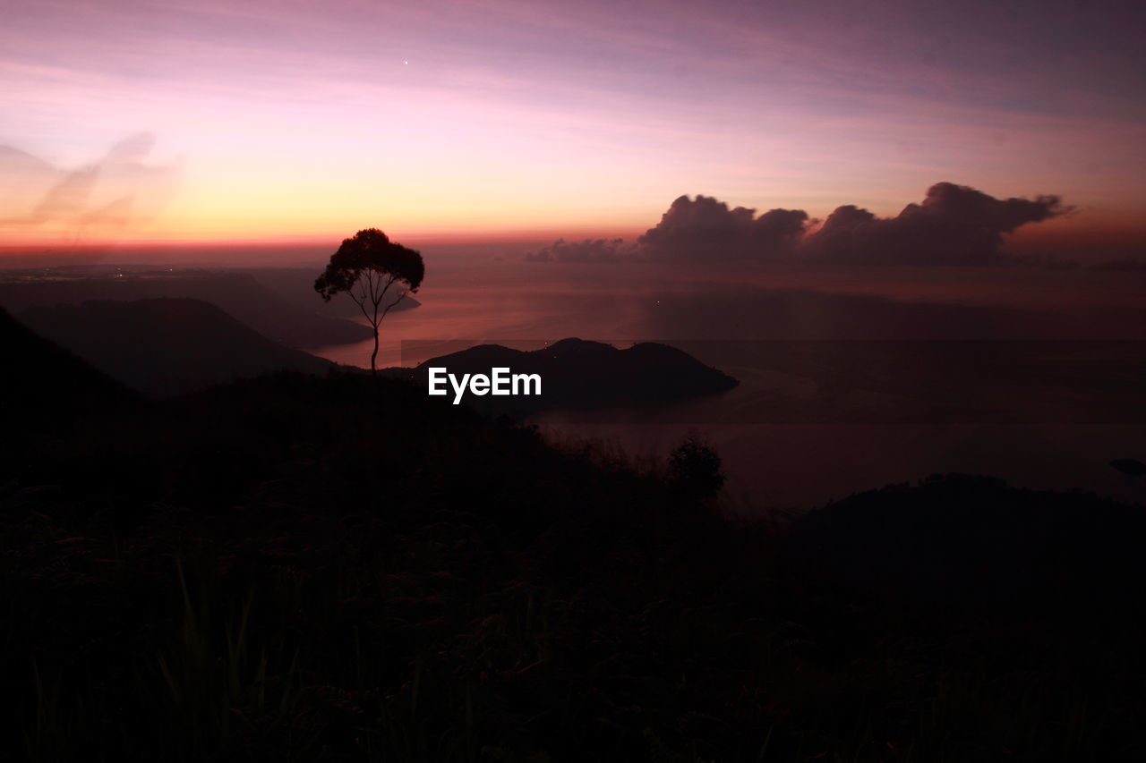 Scenic view of silhouette mountains against sky during sunset