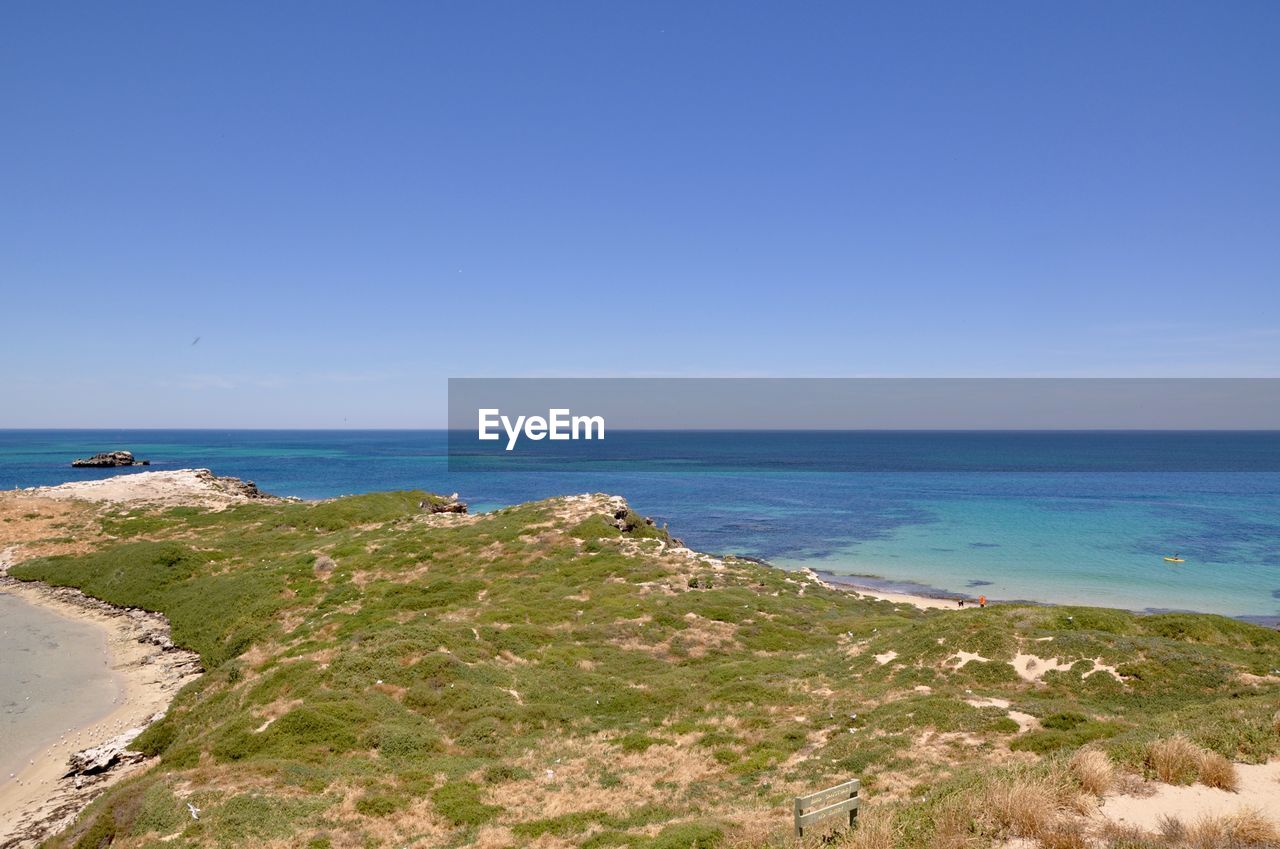 Scenic view of sea against clear blue sky