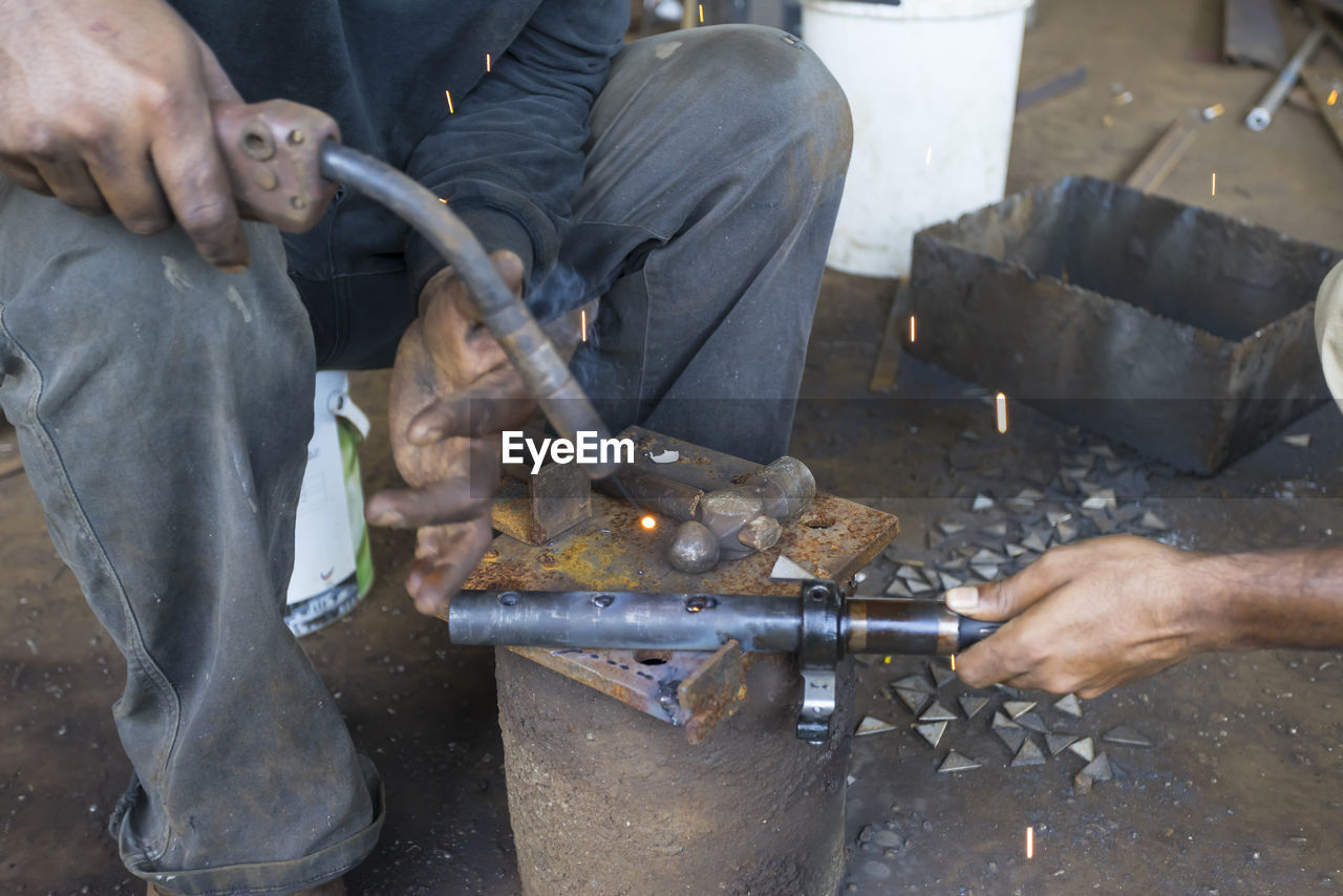 MIDSECTION OF MAN WORKING WITH PEOPLE