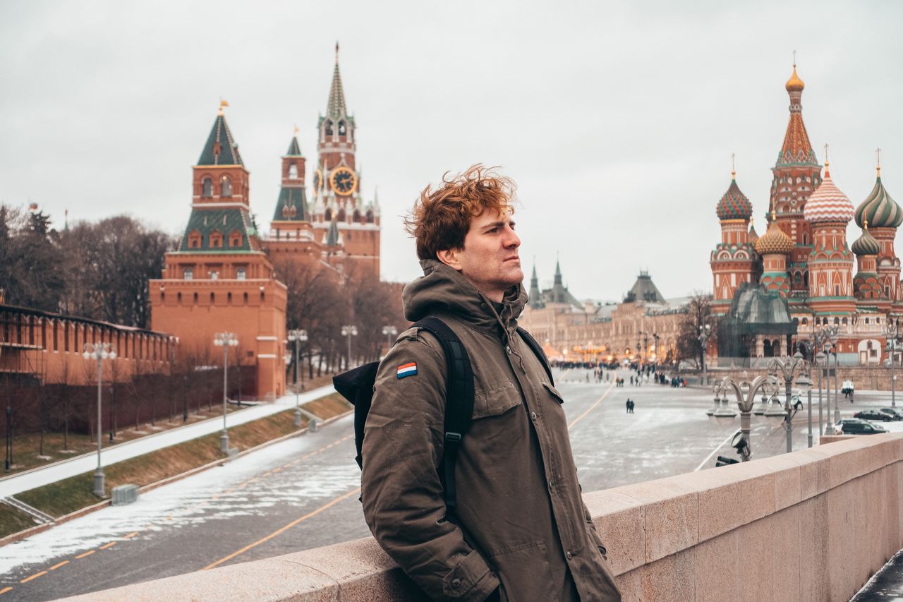 FULL LENGTH OF MAN STANDING IN CITY AGAINST SKY