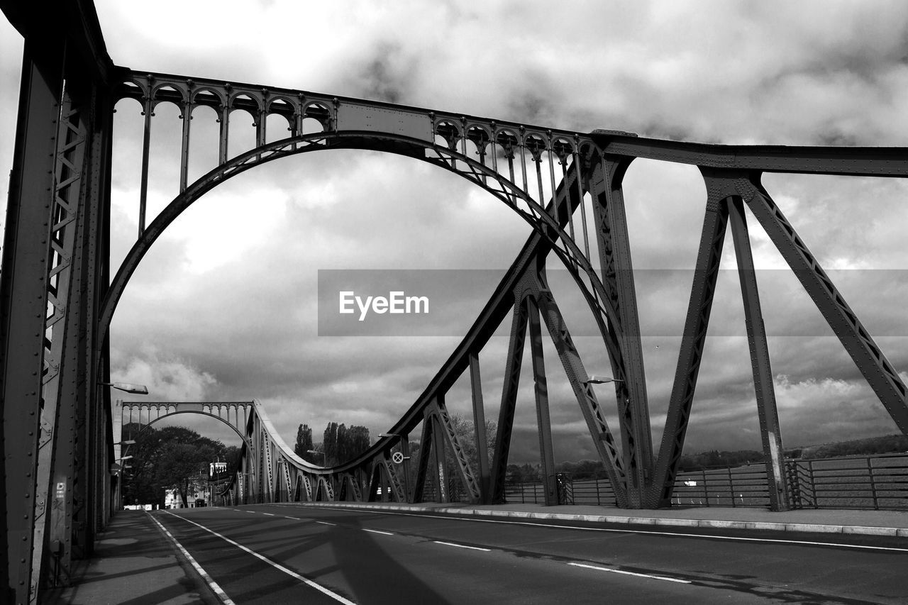 SUSPENSION BRIDGE AGAINST CLOUDY SKY