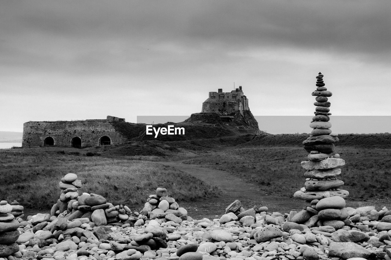 STONE STACK ON ROCK AGAINST SKY