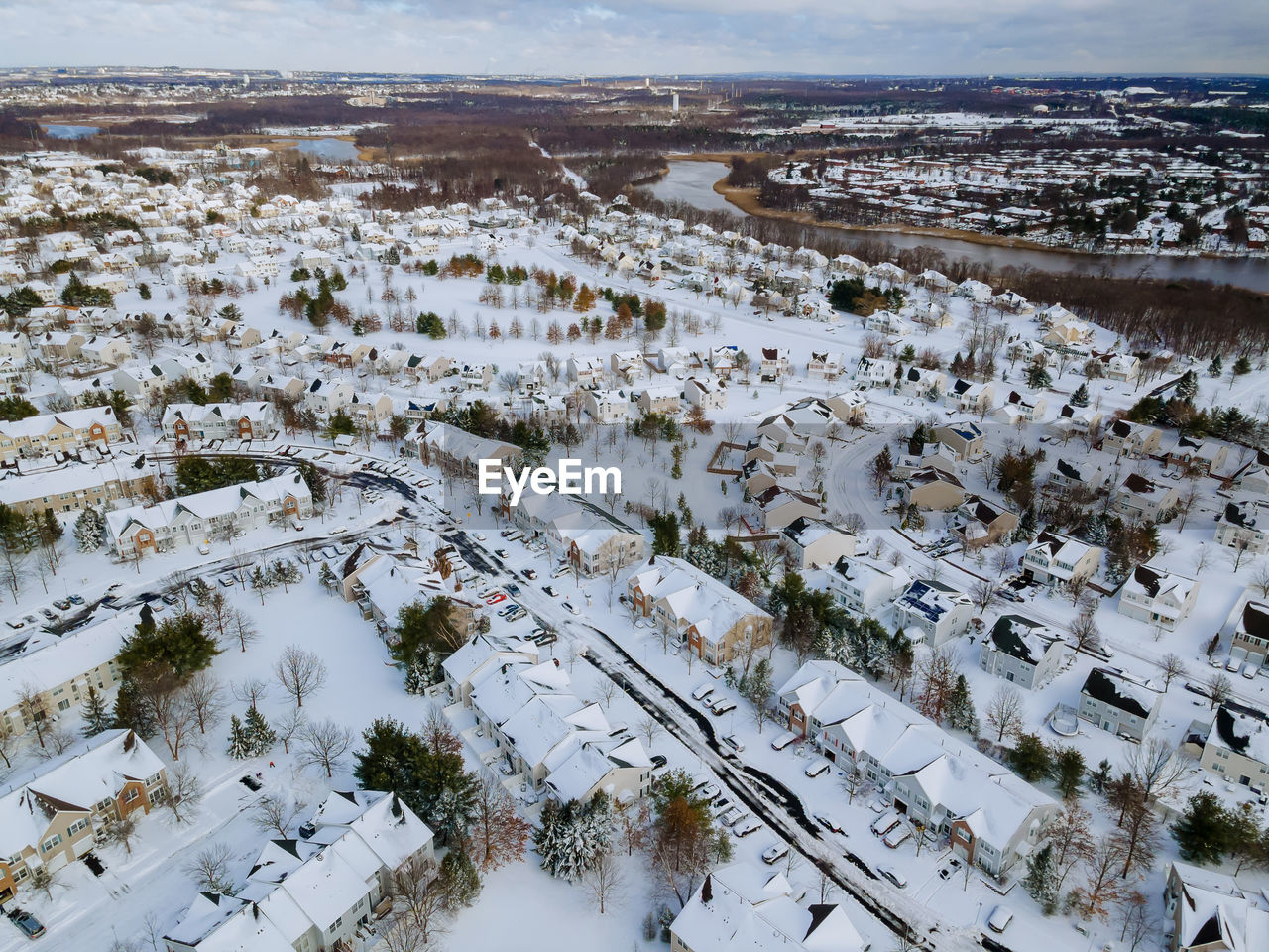 HIGH ANGLE VIEW OF SNOW COVERED LANDSCAPE AND BUILDINGS