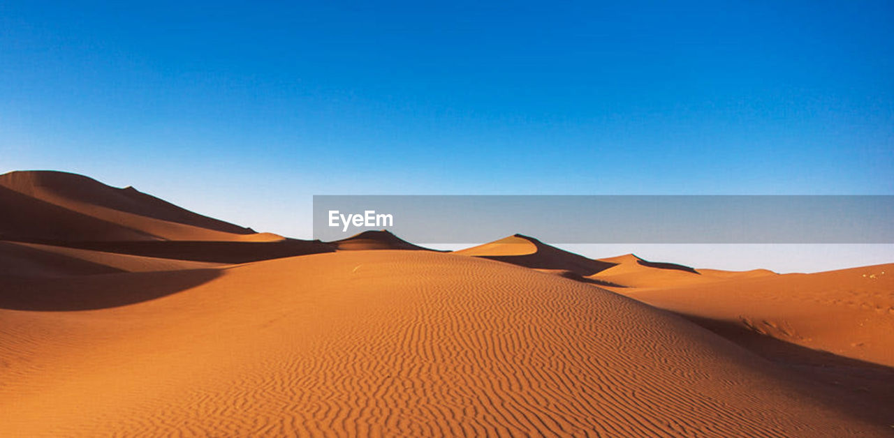 Scenic view of desert against clear sky