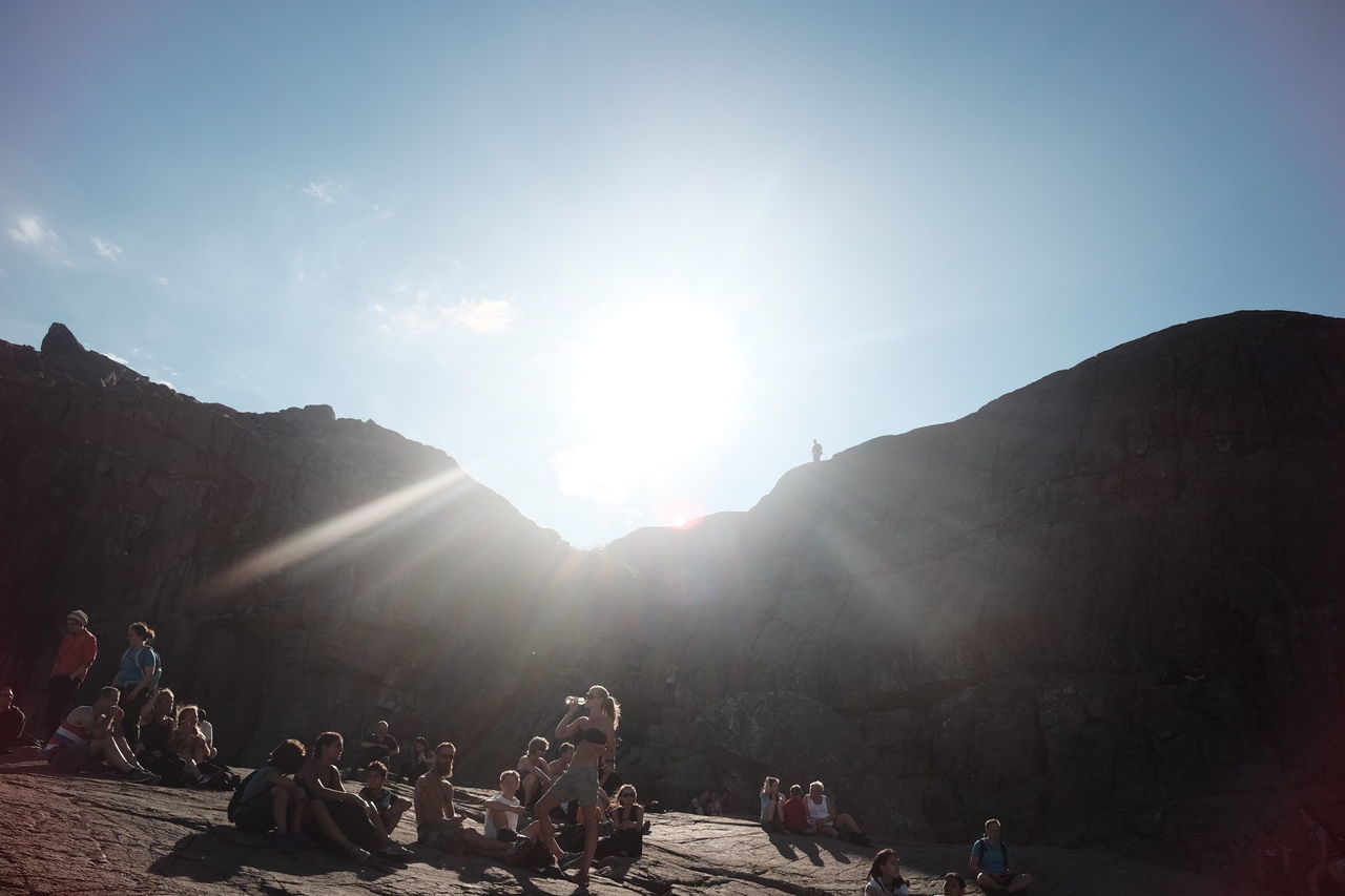 PEOPLE ON MOUNTAINS AGAINST SKY