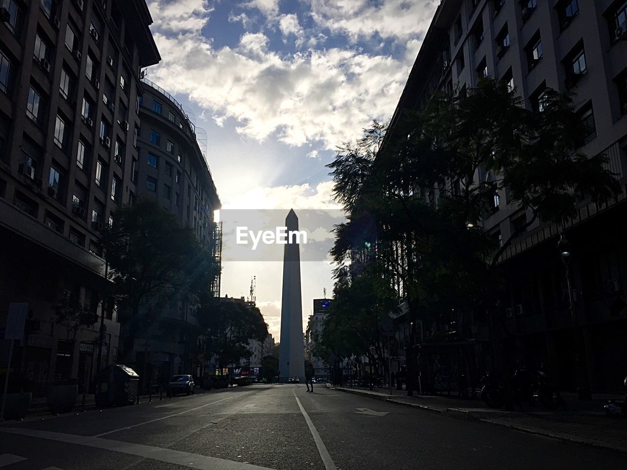 Empty road with buildings in background