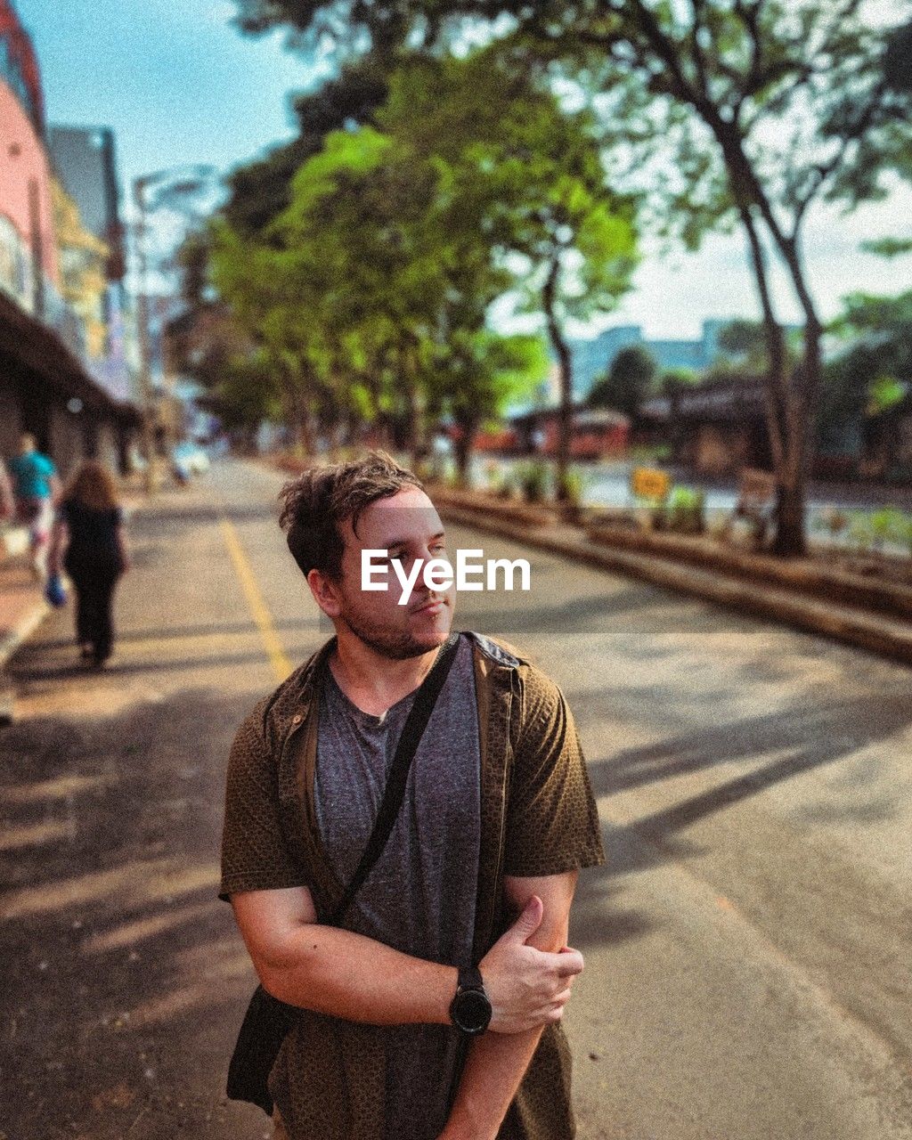 Portrait of young man standing on street