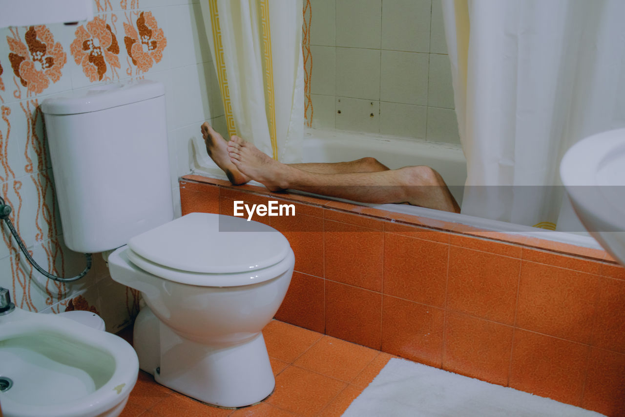 Low section of woman in bathtub