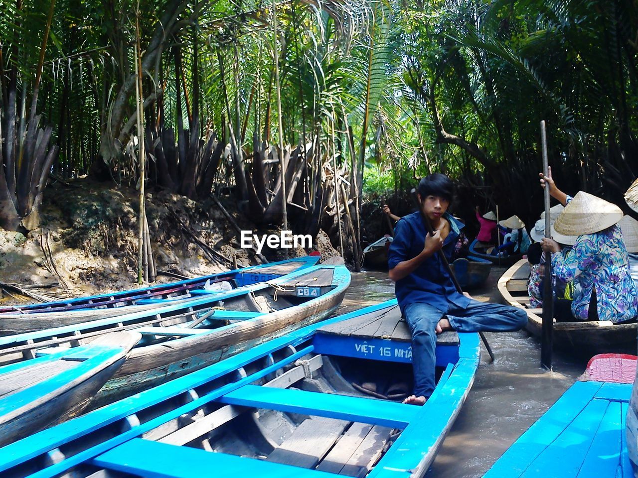 MEN SITTING ON BOAT