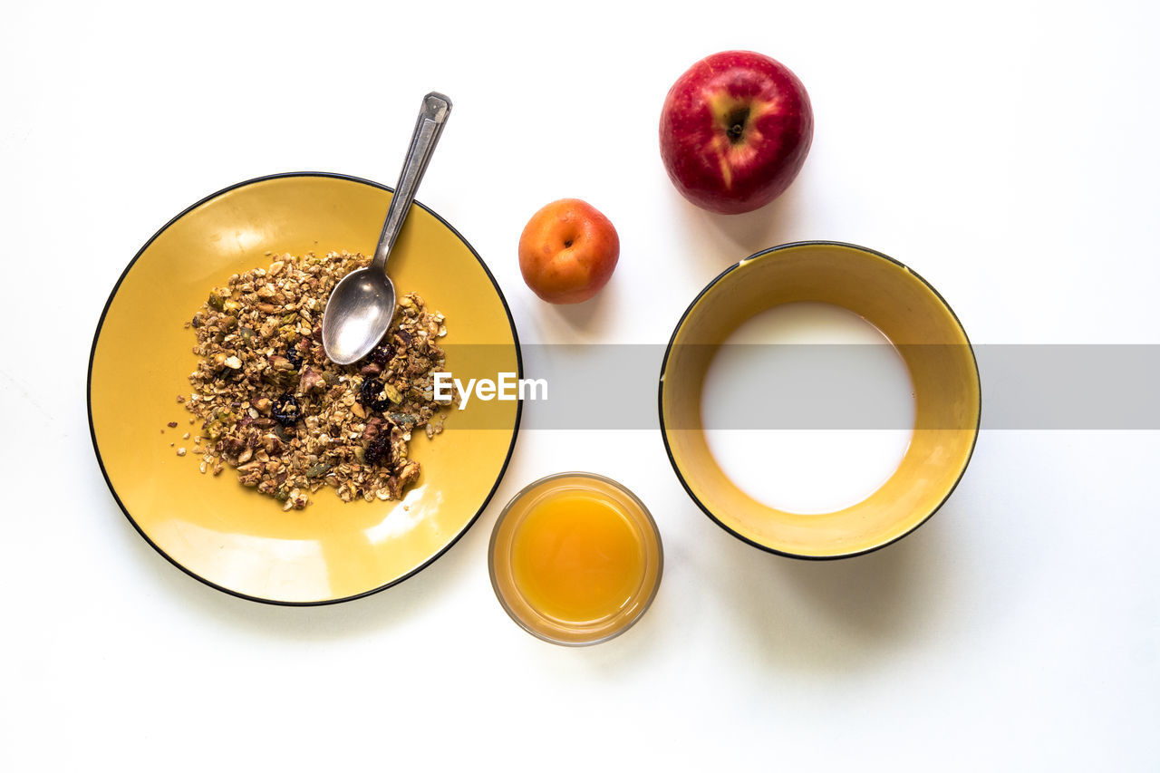 Directly above view of breakfast and fruits on white background