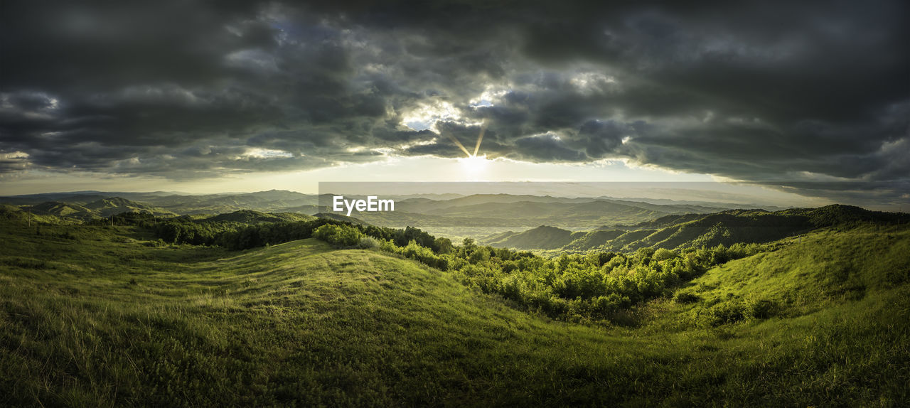 Scenic view of landscape against cloudy sky