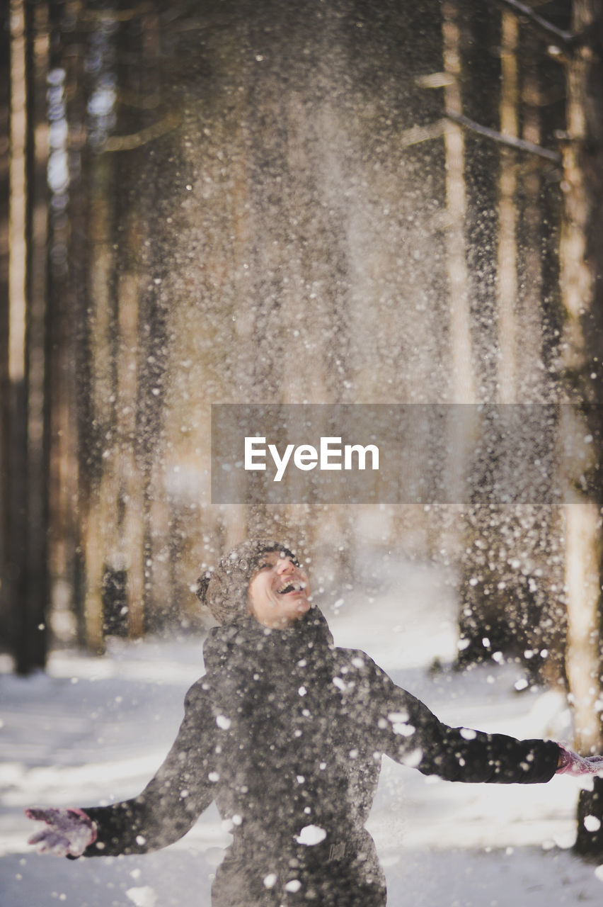 Woman throwing while playing with snow