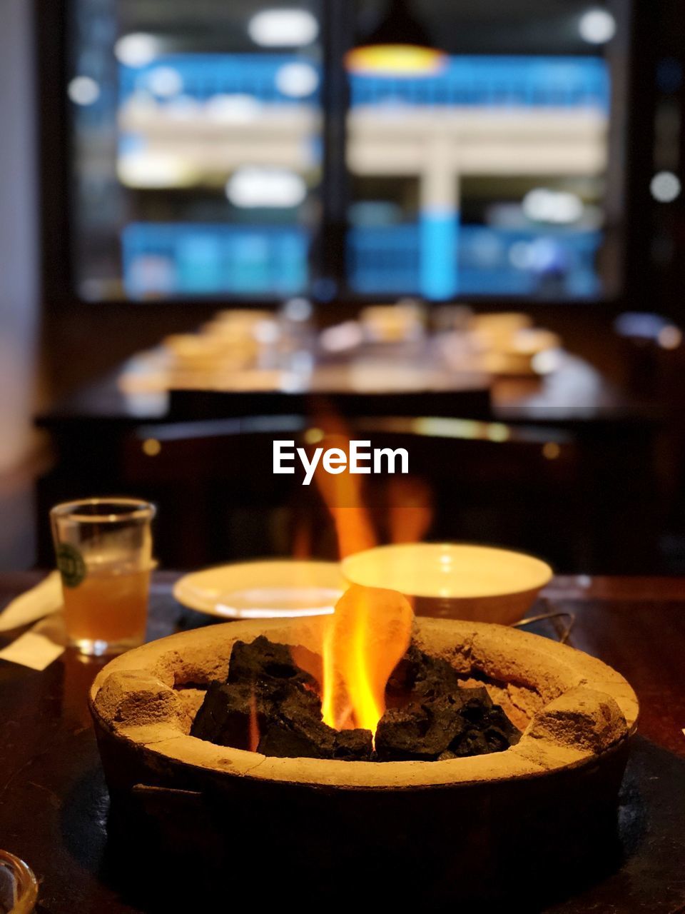 Coals burning on table at restaurant