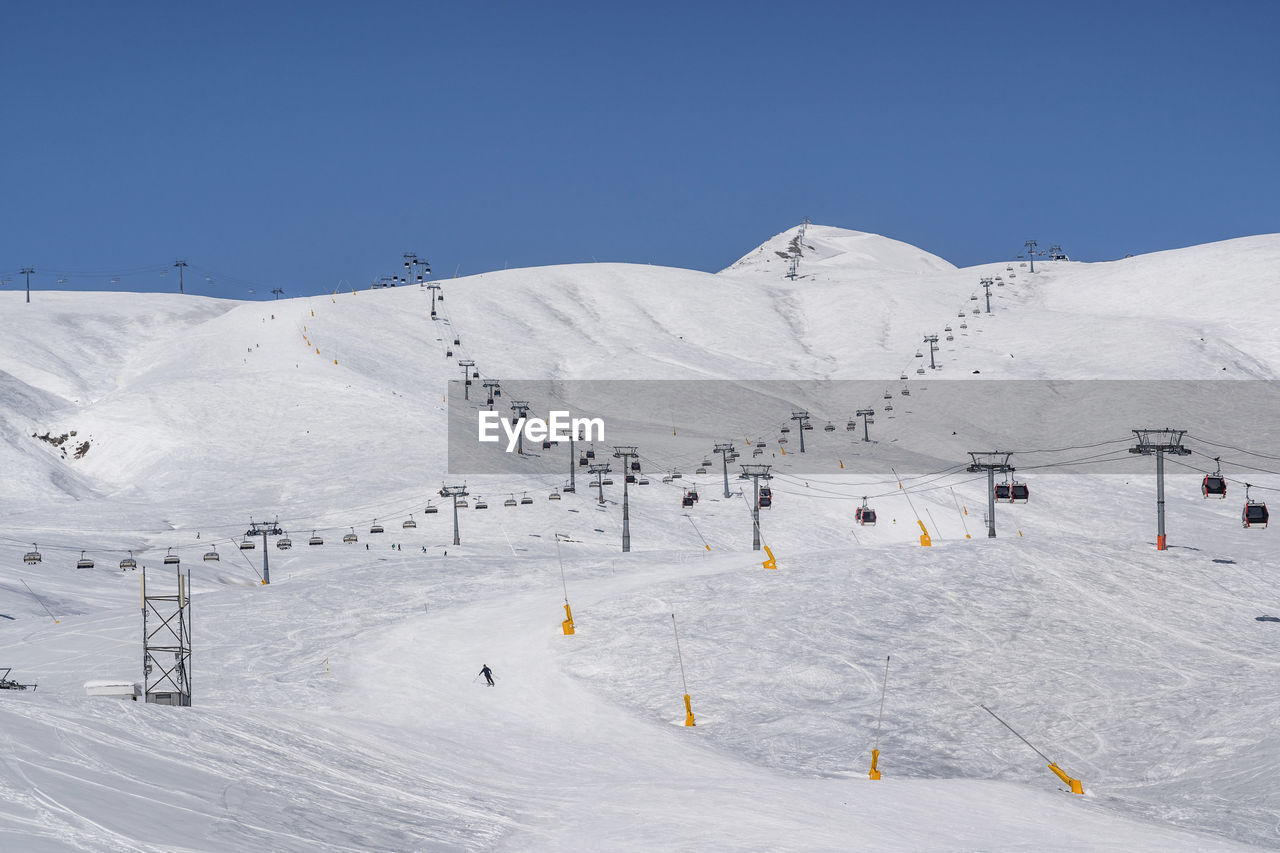 Snowy slopes with gondola and chair lift. ski resort gudauri, georgia. caucasus mountains