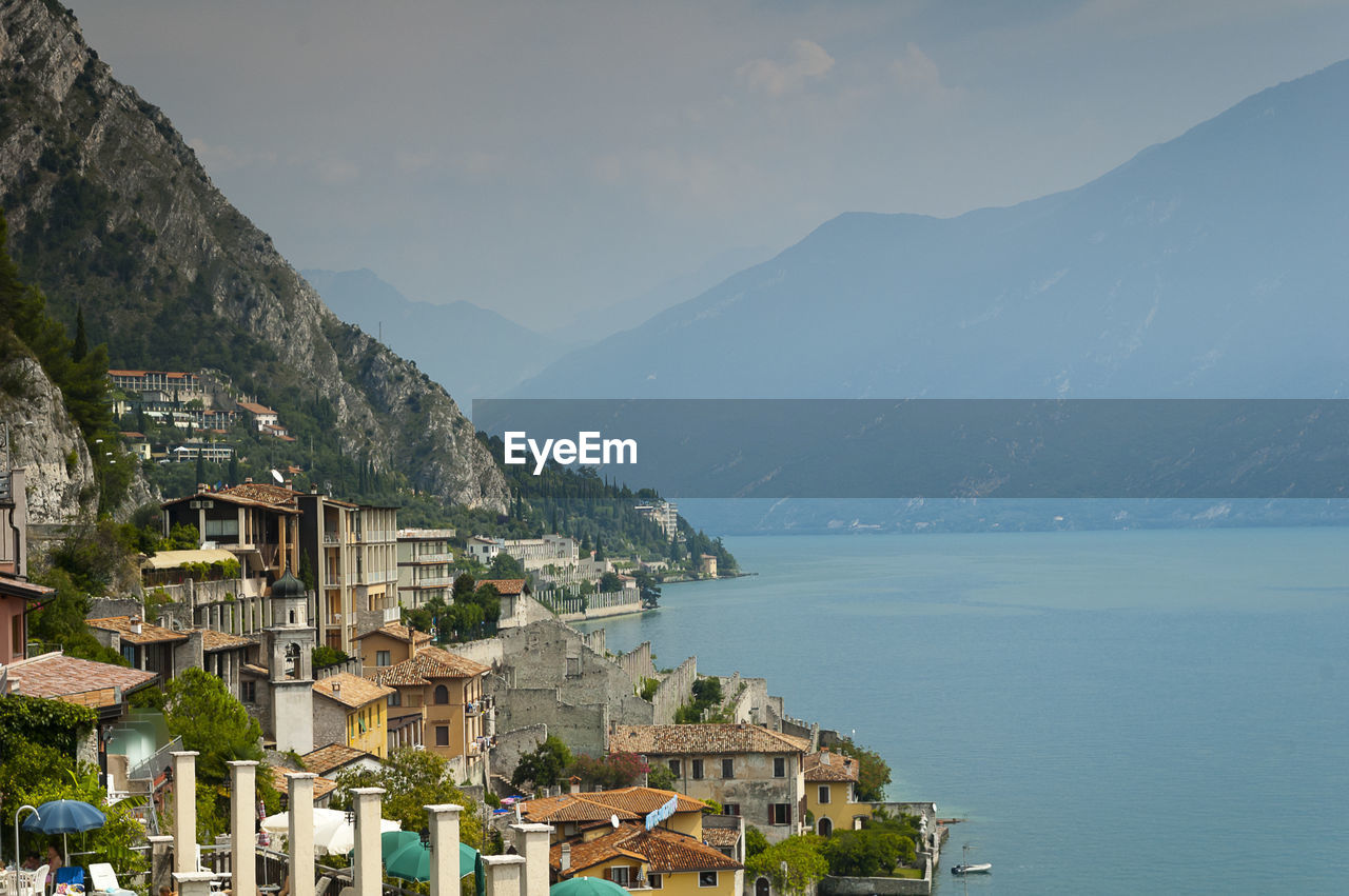 Townscape by garda lake against sky