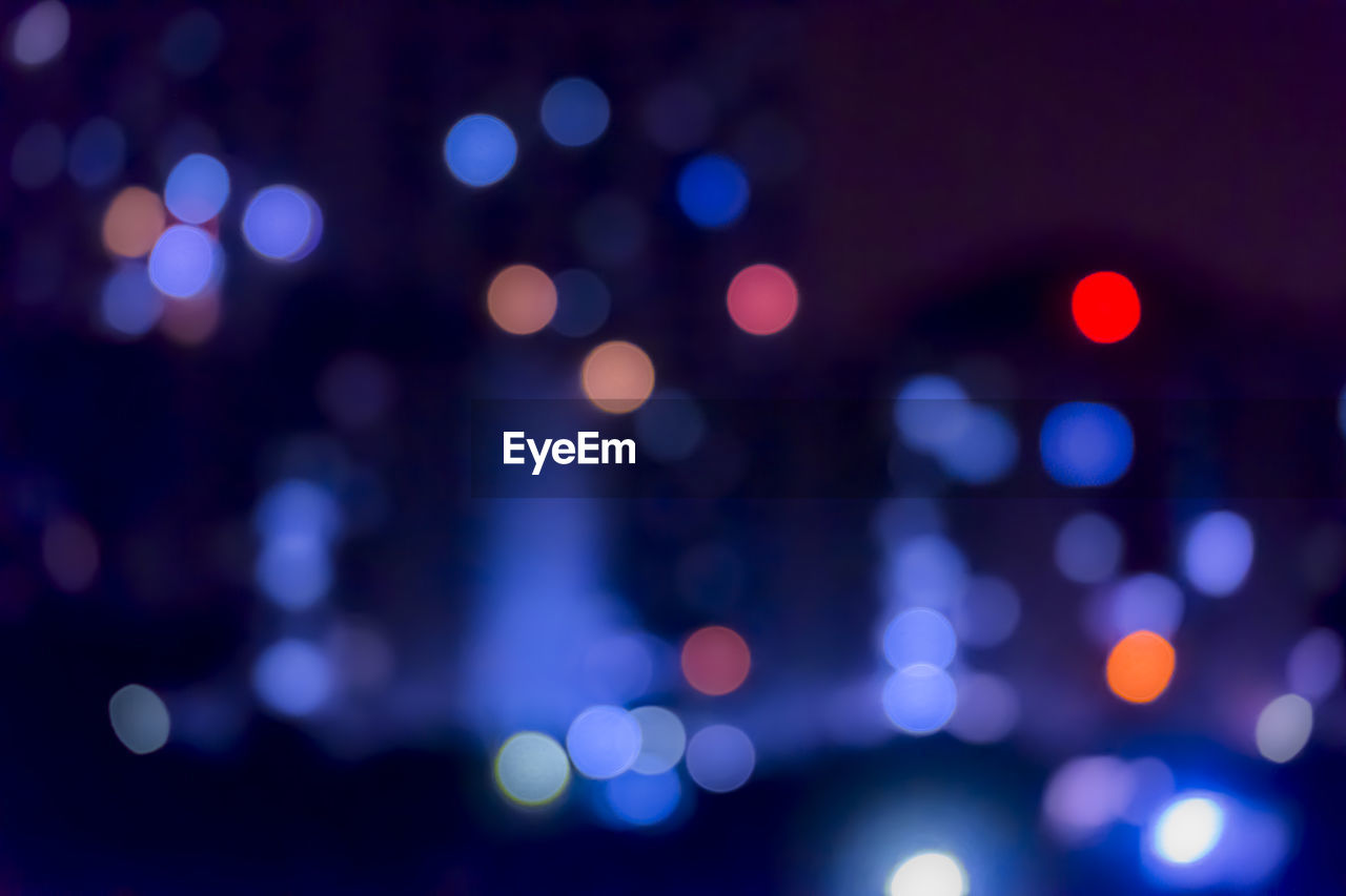 DEFOCUSED IMAGE OF LIGHTS AT NIGHT