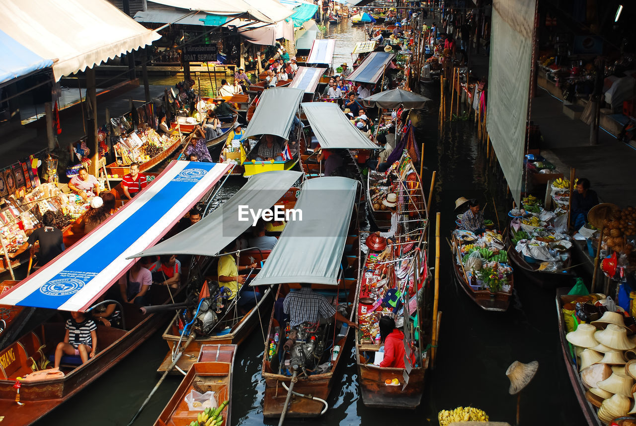 High angle view of people in boat moored at canal