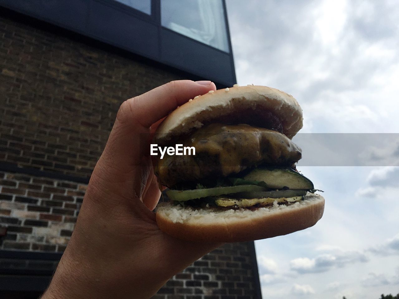 Cropped image of hand holding burger