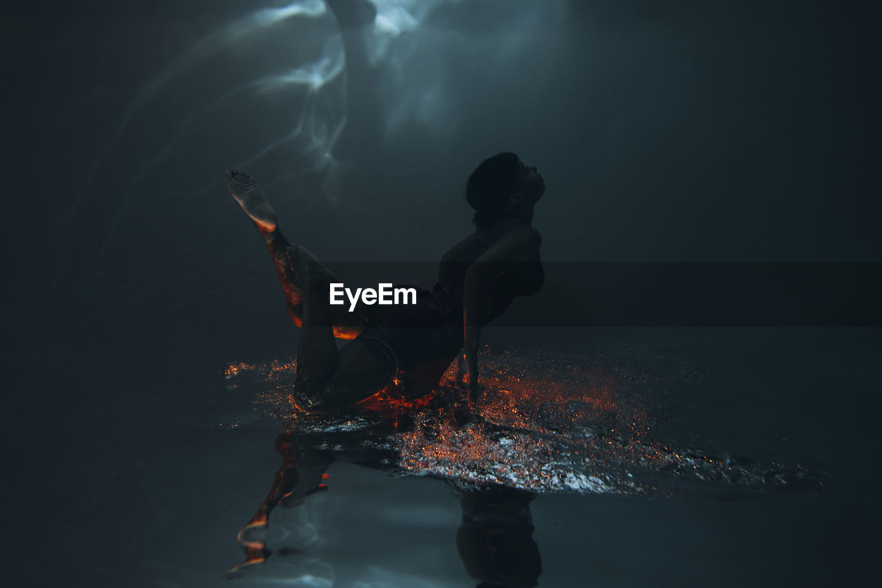 Young woman swimming underwater in sea
