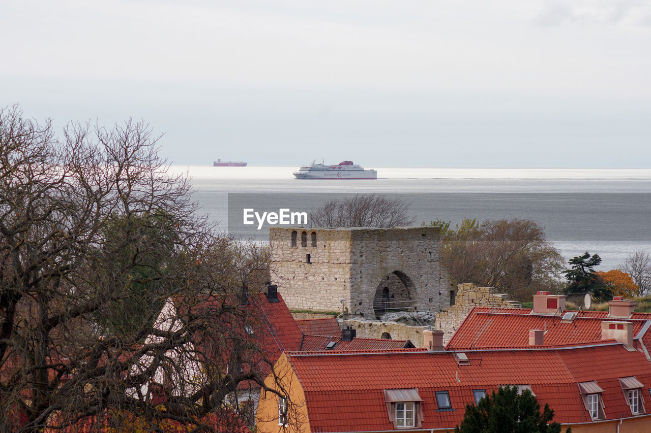 BUILDINGS AND SEA AGAINST SKY