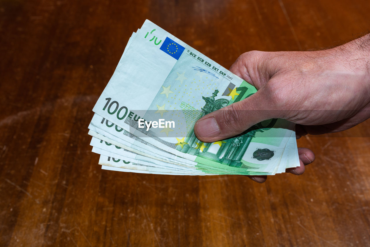 Close-up of hand holding paper currency