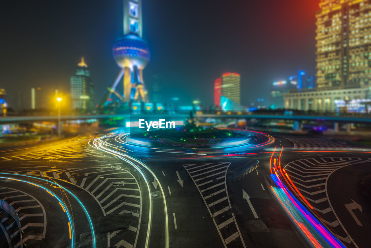 LIGHT TRAILS ON ROAD IN CITY