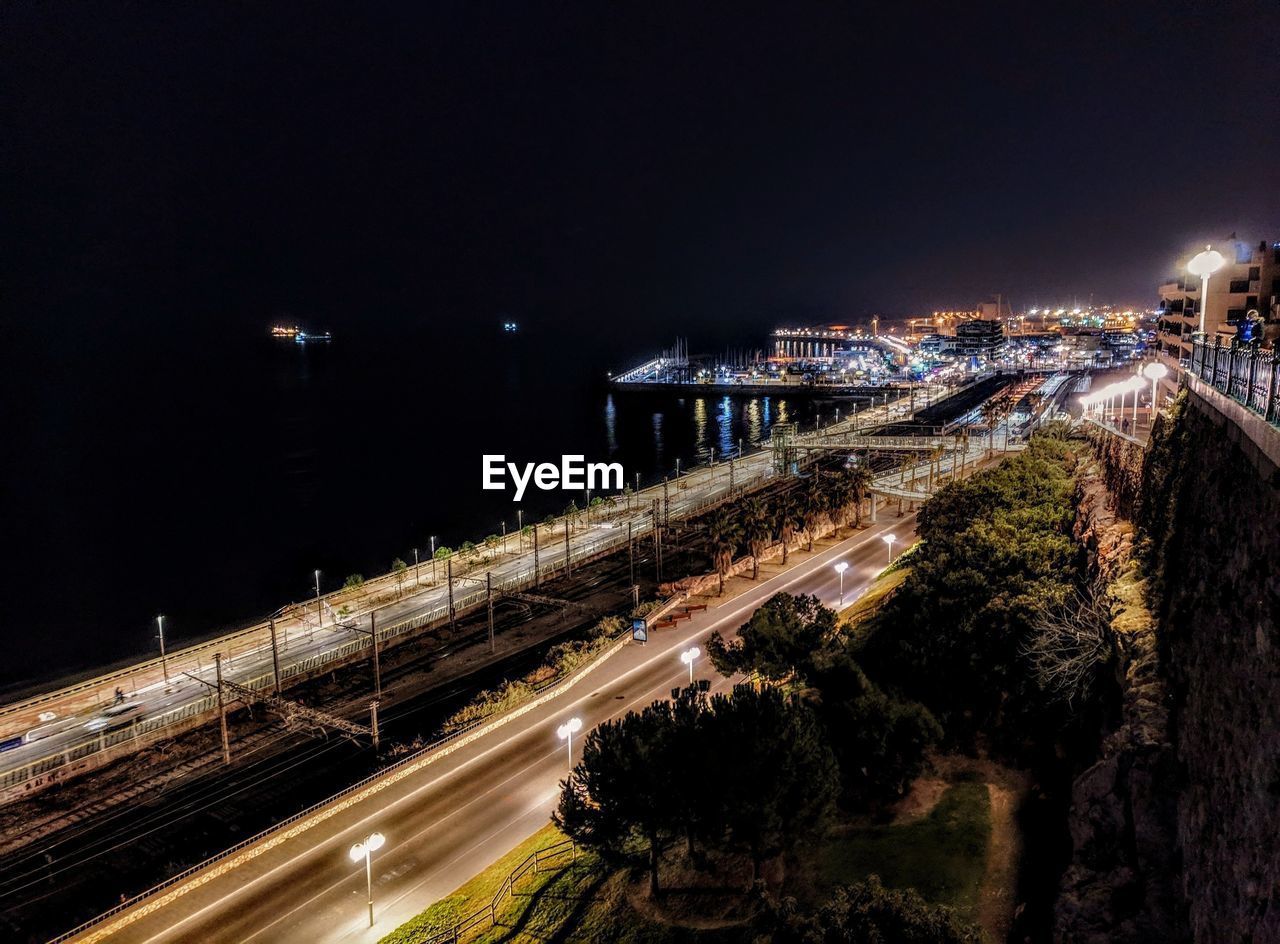 High angle view of light trails on road against sky at night