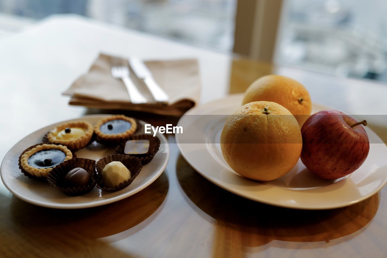 Close-up of fruits and dessert on table