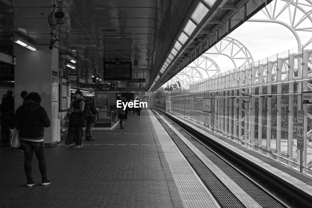 PEOPLE ON RAILROAD STATION PLATFORM