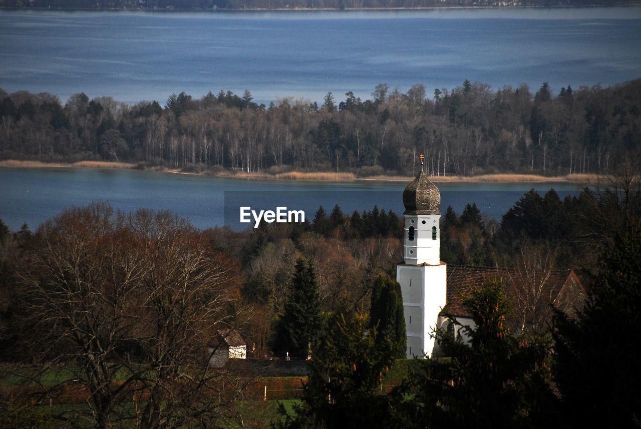 Church on field against river