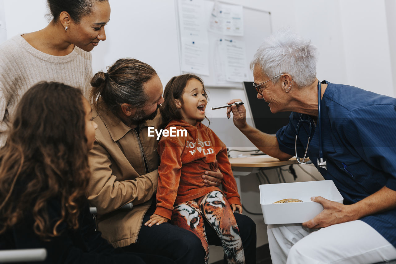 Parents with daughter in doctors office