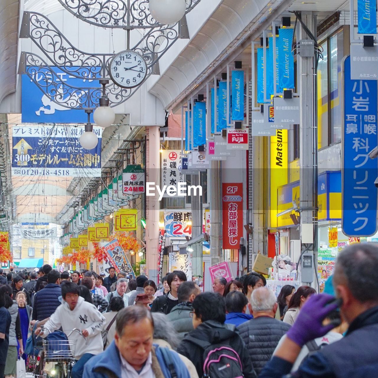 PEOPLE ON STREET AGAINST BUILDINGS