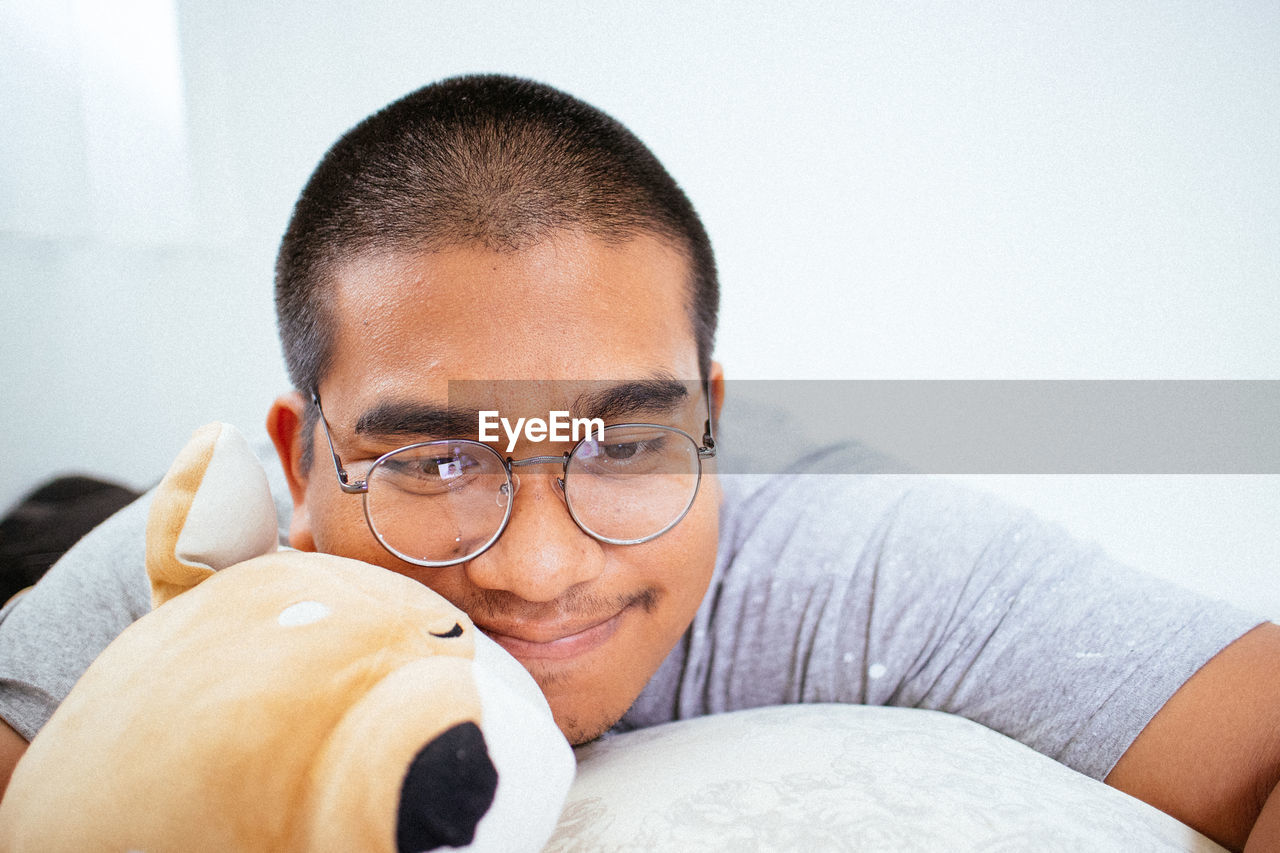 CLOSE-UP PORTRAIT OF YOUNG MAN WEARING EYEGLASSES