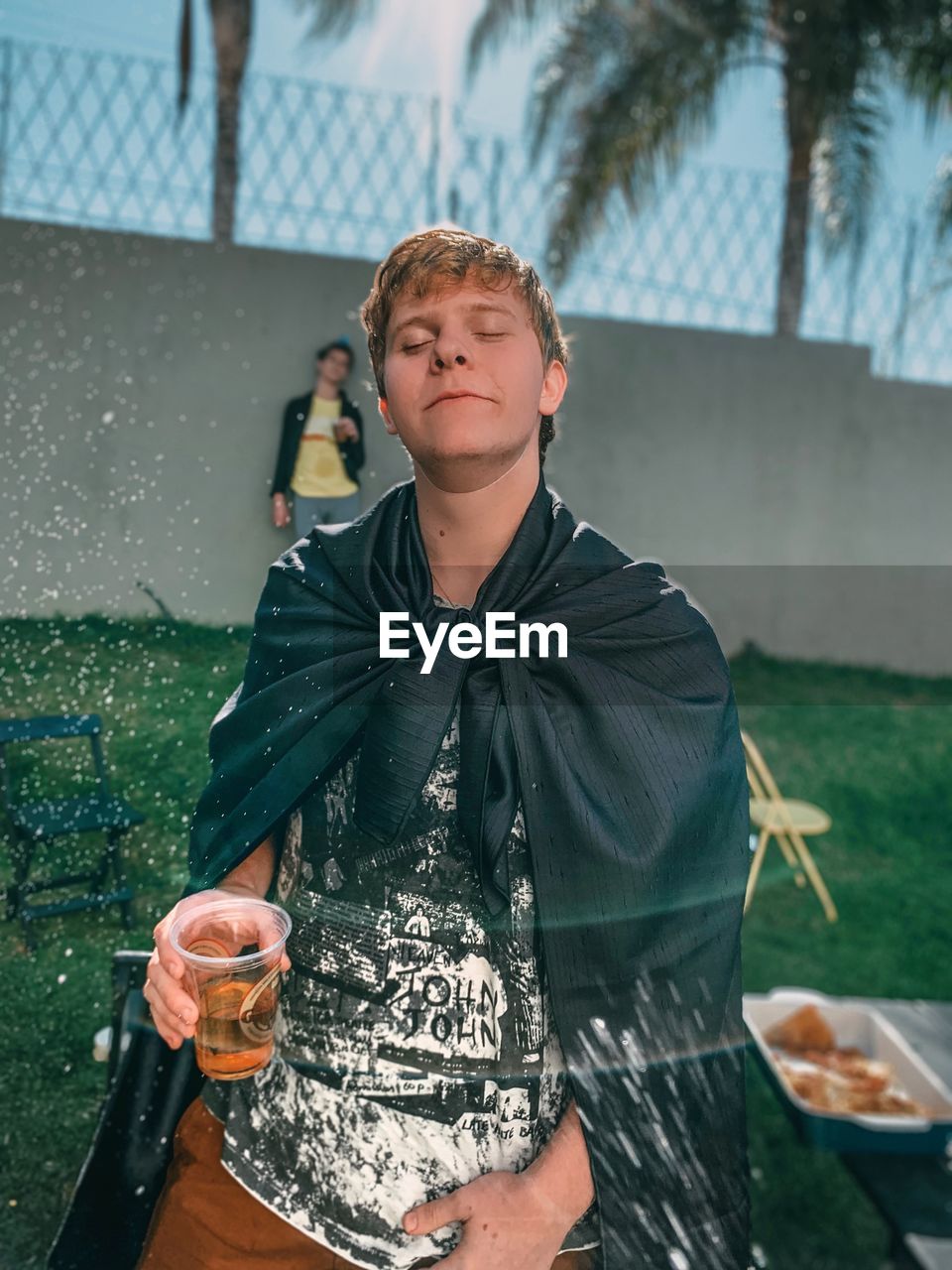 PORTRAIT OF TEENAGE BOY DRINKING WATER