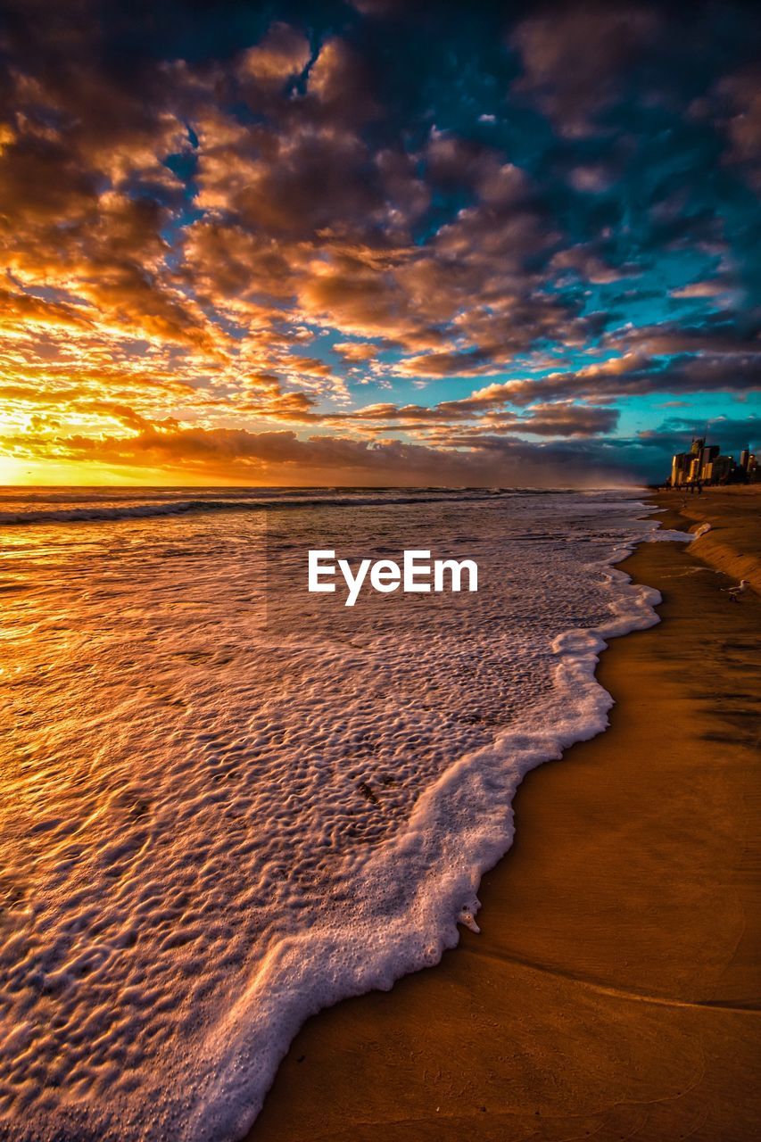 Scenic view of beach against sky during sunset