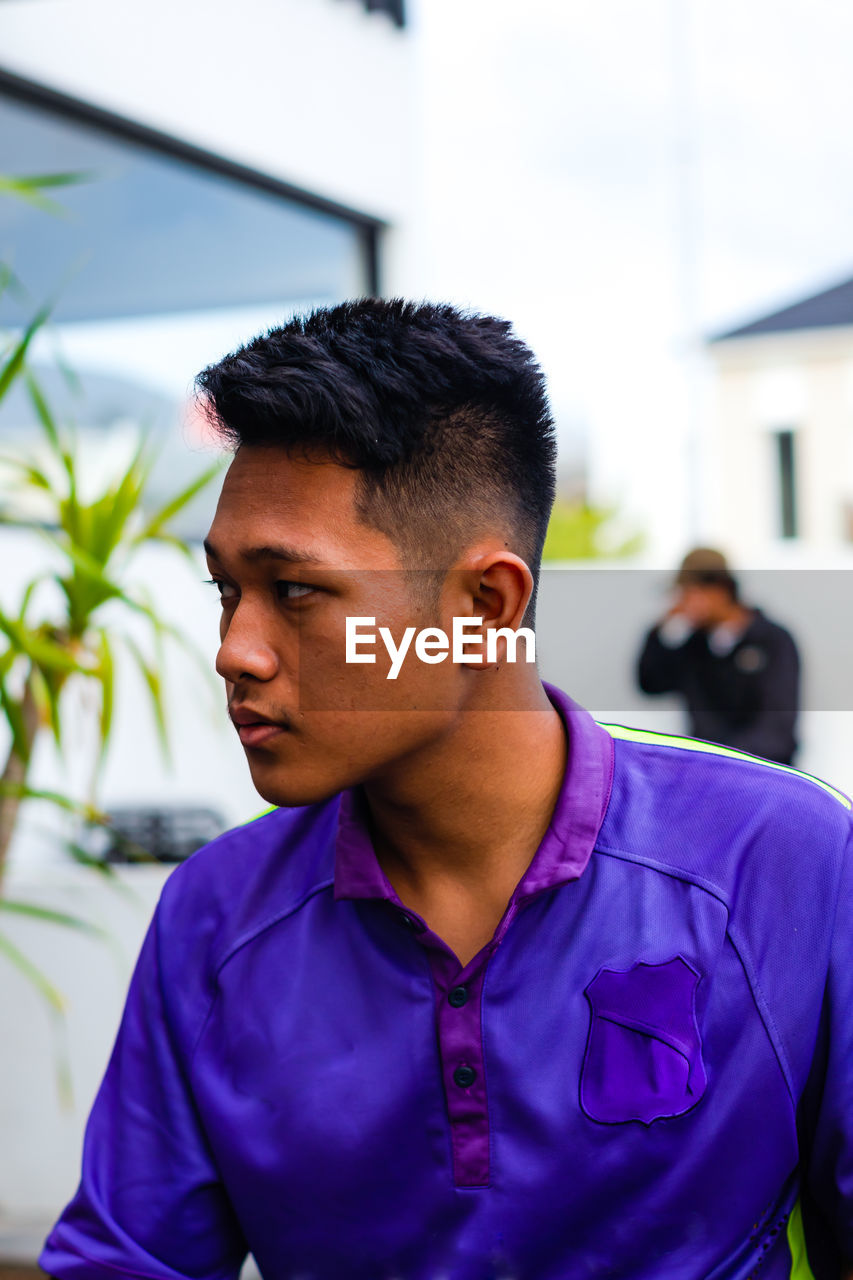 Portrait of young man looking away