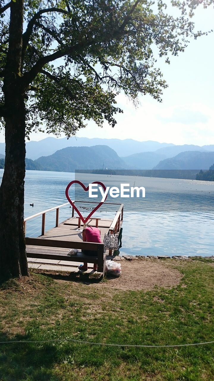 Hear shape frame on edge of scenic mountain lake