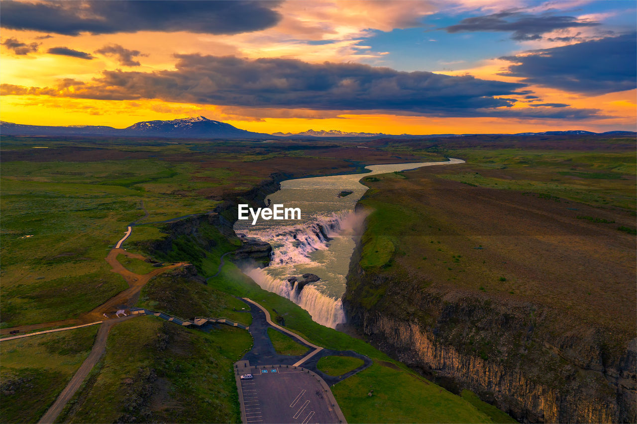 scenic view of landscape against sky at sunset