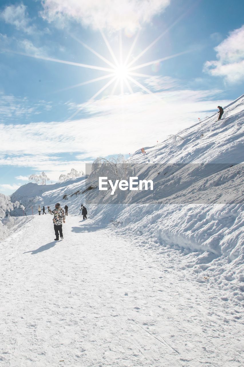 people skiing on snow covered landscape