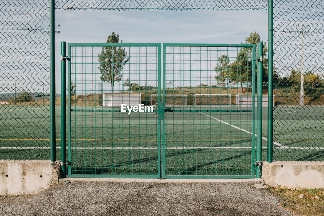 View of soccer field seen through fence