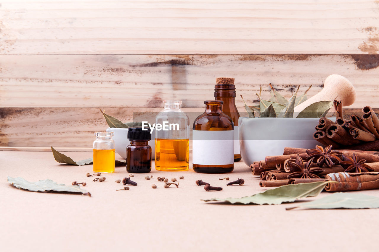 Various cooking oils in bottles by spices on table