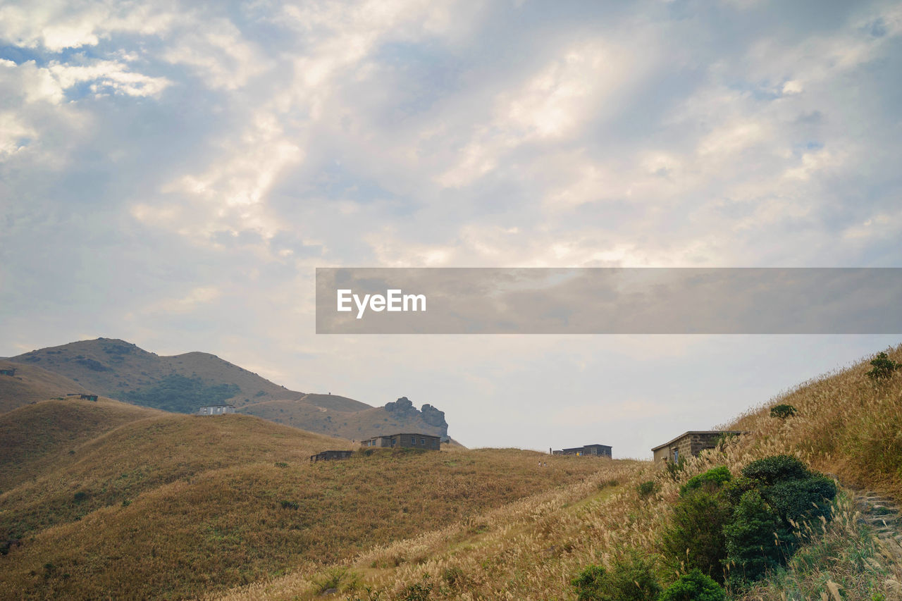 SCENIC VIEW OF LAND AND MOUNTAINS AGAINST SKY