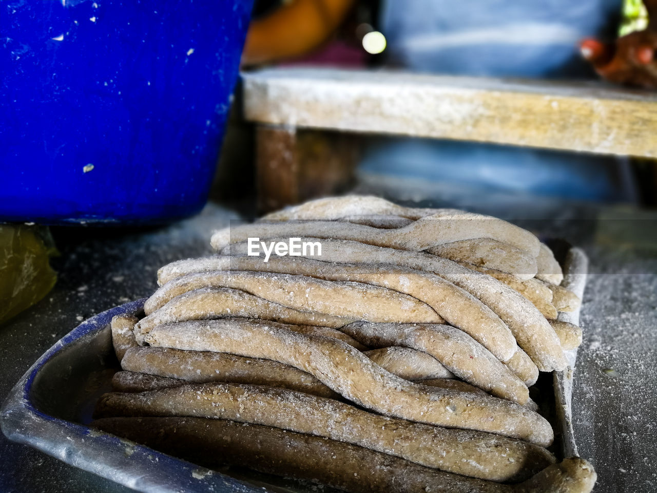 Unidentified hand is making a keropok lekor, a local delicacy made from fish and starch.