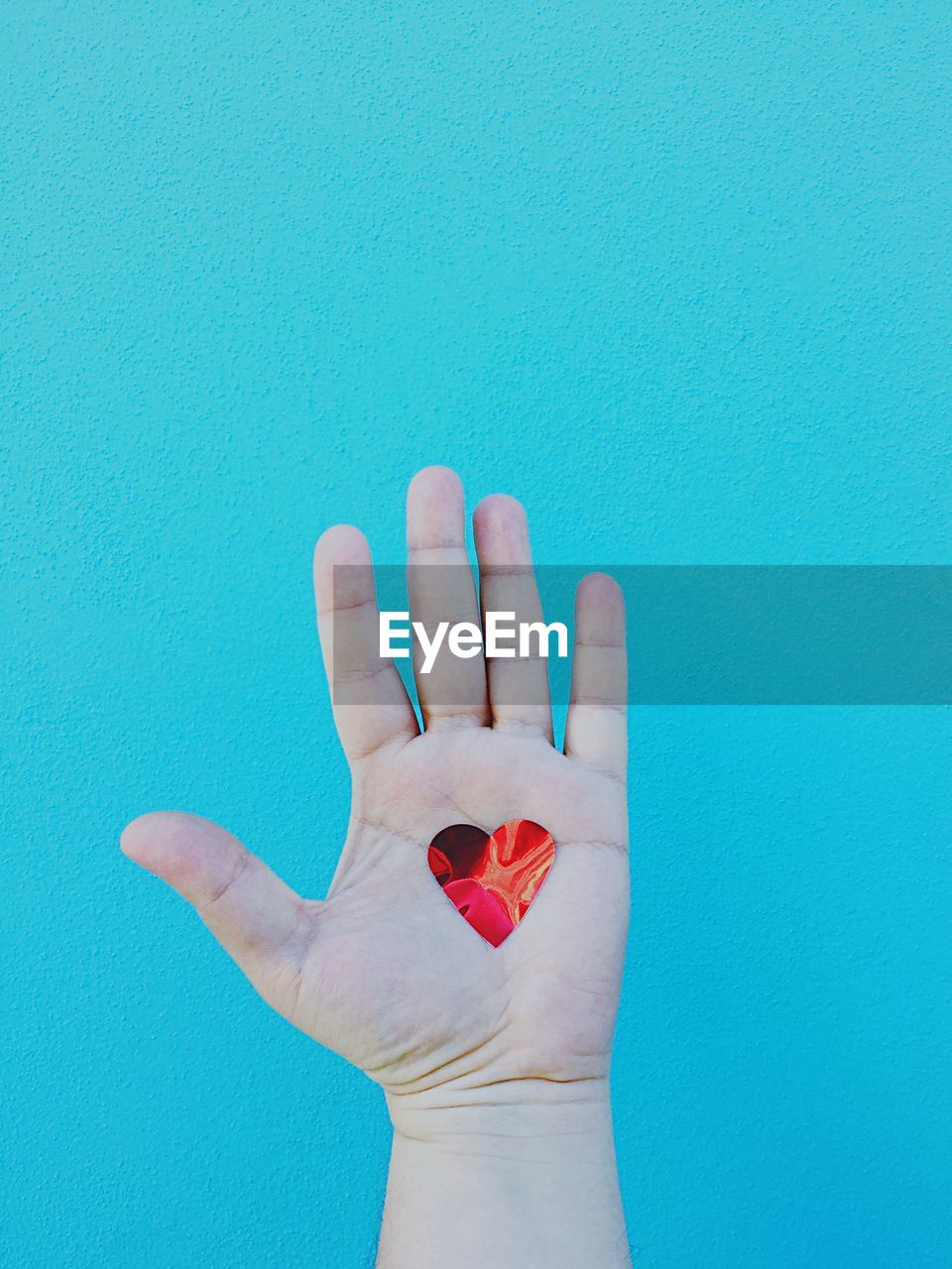 High angle view of heart shape on mans palm